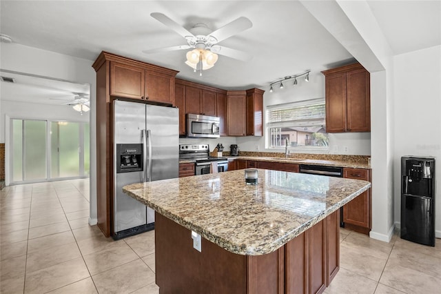 4023 SW 19th St, Gainesville, FL 32608 - kitchen featuring stainless steel appliances, ceiling fan, a sink, light stone countertops, and light tile patterned floors