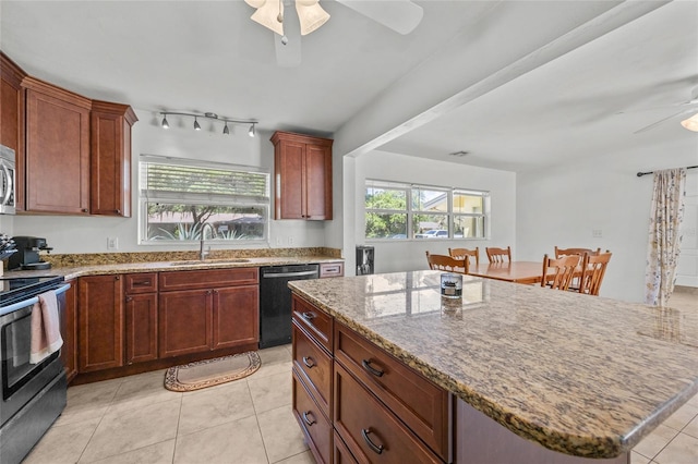4023 SW 19th St, Gainesville, FL 32608 - kitchen with appliances with stainless steel finishes, a ceiling fan, a sink, and light stone counters