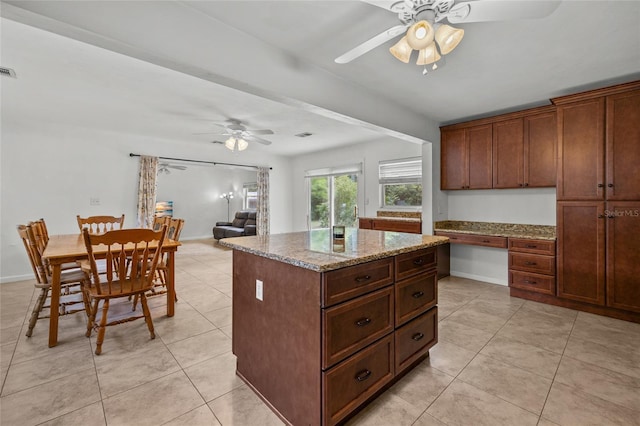 4023 SW 19th St, Gainesville, FL 32608 - kitchen featuring ceiling fan, light tile patterned flooring, and a kitchen island