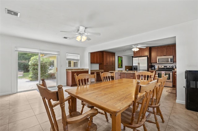 4023 SW 19th St, Gainesville, FL 32608 - dining room featuring ceiling fan, light tile patterned flooring, and baseboards