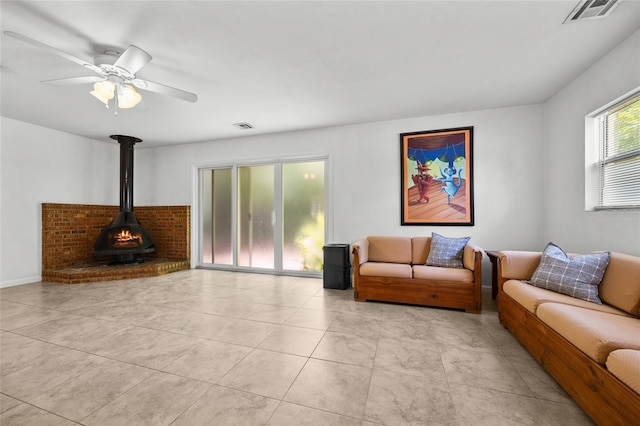 4023 SW 19th St, Gainesville, FL 32608 - living area with a wood stove, ceiling fan, and light tile patterned floors