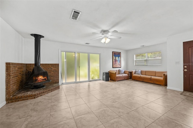 4023 SW 19th St, Gainesville, FL 32608 - living area featuring a ceiling fan, light tile patterned floors, and a wood stove