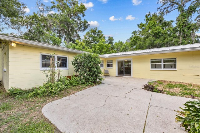 4023 SW 19th St, Gainesville, FL 32608 - rear view of property featuring a patio area, concrete block siding, and metal roof