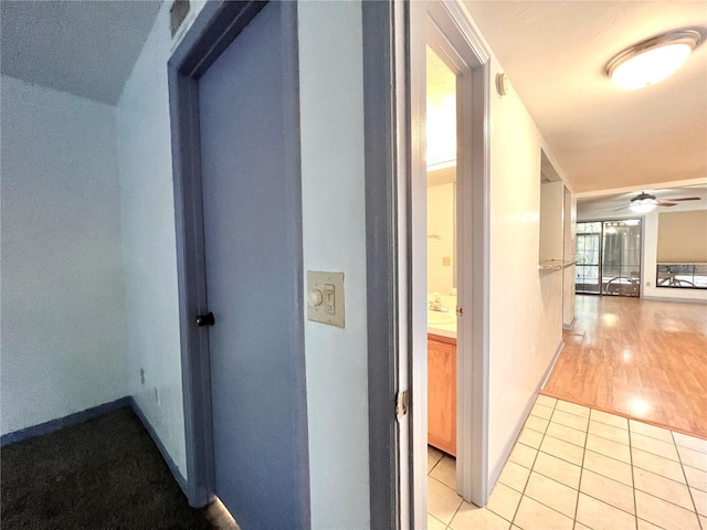 5830 SW 9th Pl, Gainesville, FL 32607 - hall featuring light tile patterned floors and baseboards