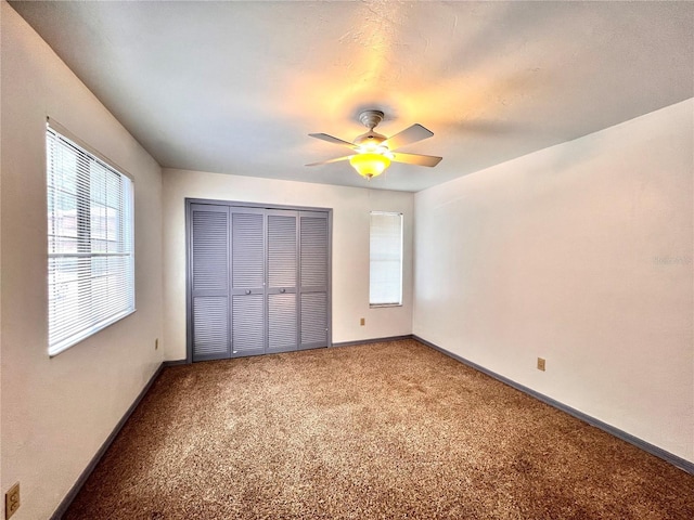 5830 SW 9th Pl, Gainesville, FL 32607 - unfurnished bedroom with light colored carpet, a closet, baseboards, and ceiling fan