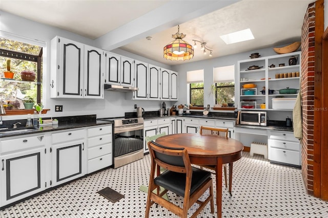 535 NE 9th Ave, Gainesville, FL 32601 - kitchen with stainless steel appliances, a sink, dark countertops, under cabinet range hood, and light flooring