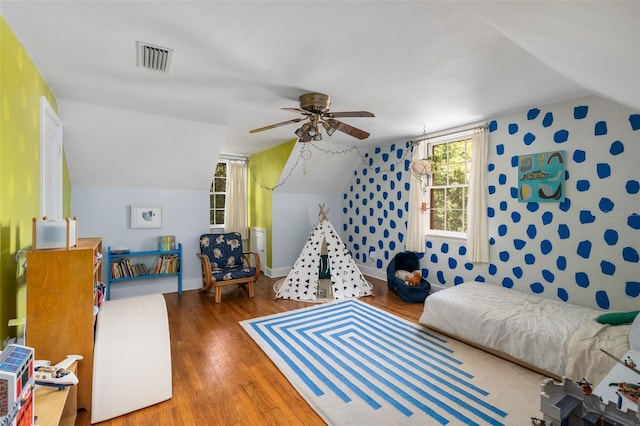 535 NE 9th Ave, Gainesville, FL 32601 - bedroom with vaulted ceiling, wood finished floors, wallpapered walls, and a ceiling fan