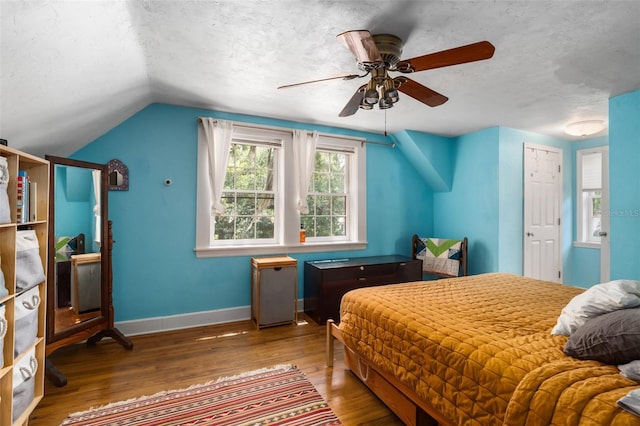 535 NE 9th Ave, Gainesville, FL 32601 - bedroom featuring baseboards, wood finished floors, vaulted ceiling, a textured ceiling, and ceiling fan