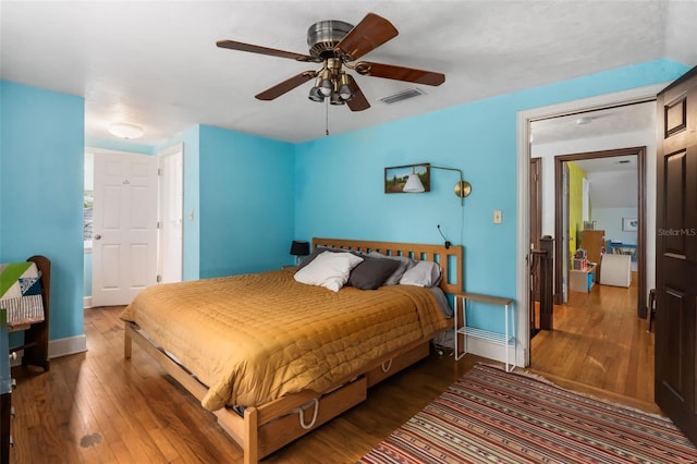 535 NE 9th Ave, Gainesville, FL 32601 - bedroom with wood finished floors, baseboards, and a ceiling fan