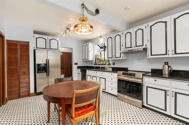 535 NE 9th Ave, Gainesville, FL 32601 - kitchen featuring stainless steel appliances, under cabinet range hood, a sink, dark countertops, and light flooring