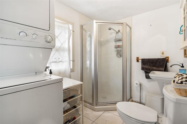 535 NE 9th Ave, Gainesville, FL 32601 - full bathroom with stacked washer / drying machine, toilet, a shower stall, and tile patterned floors