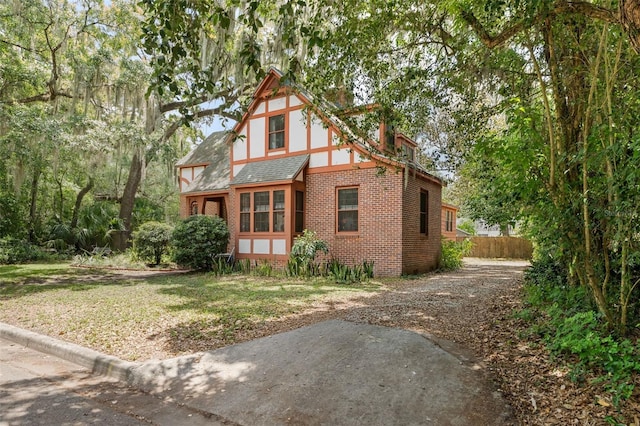 535 NE 9th Ave, Gainesville, FL 32601 - view of front of property with brick siding, a shingled roof, and driveway
