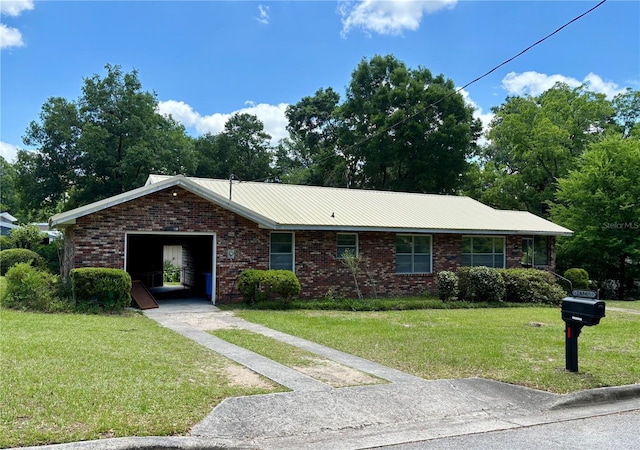 ranch-style house featuring brick siding, a front yard, and driveway