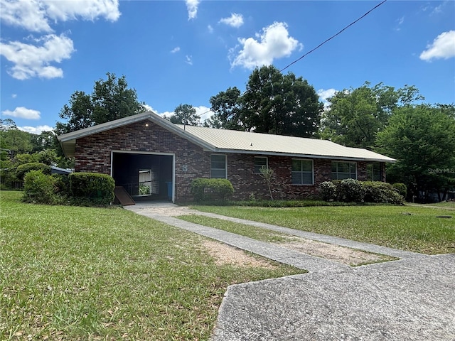 ranch-style home with a front yard, brick siding, and an attached garage