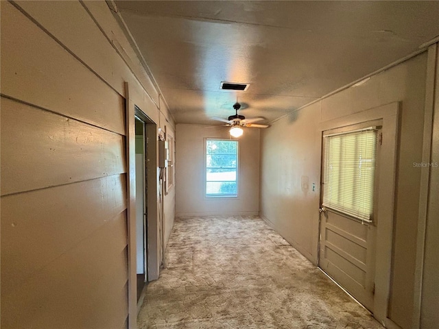 hall with light colored carpet