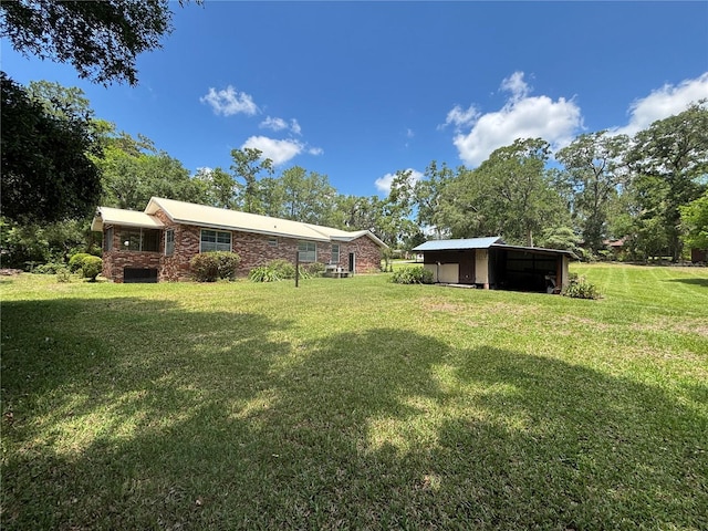 view of green lawn with an outbuilding
