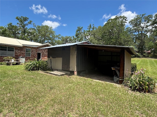 view of outdoor structure with a carport and an outbuilding