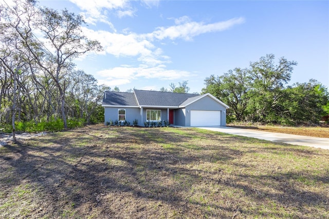 ranch-style house featuring concrete driveway, an attached garage, stucco siding, and a front lawn