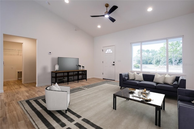 living room with ceiling fan, light wood finished floors, baseboards, high vaulted ceiling, and recessed lighting