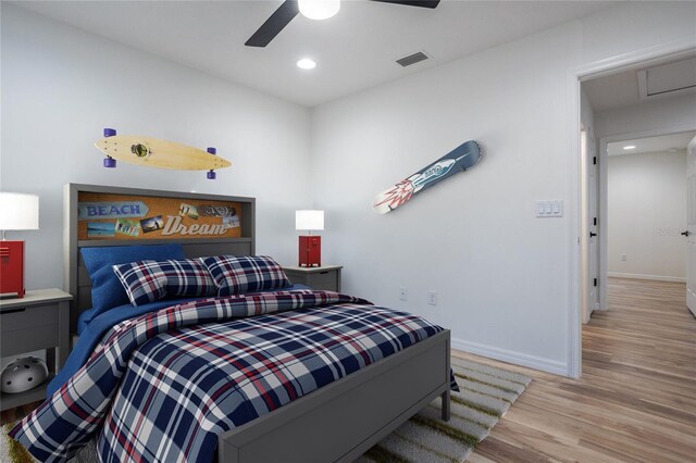 bedroom featuring wood finished floors, baseboards, recessed lighting, and a ceiling fan