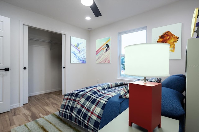 bedroom with wood finished floors, baseboards, a closet, recessed lighting, and ceiling fan