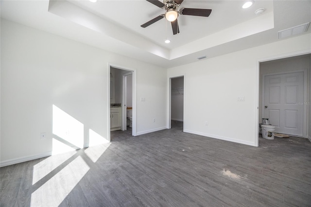 spare room with a raised ceiling, ceiling fan, baseboards, dark wood-style floors, and recessed lighting