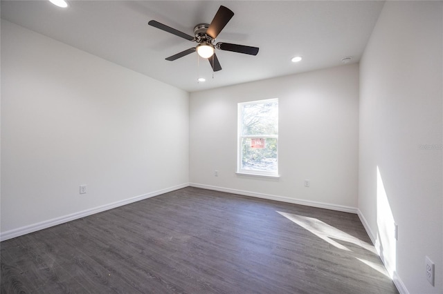 empty room featuring recessed lighting, dark wood finished floors, baseboards, and a ceiling fan