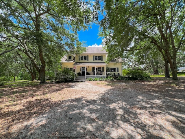 back of property featuring a porch