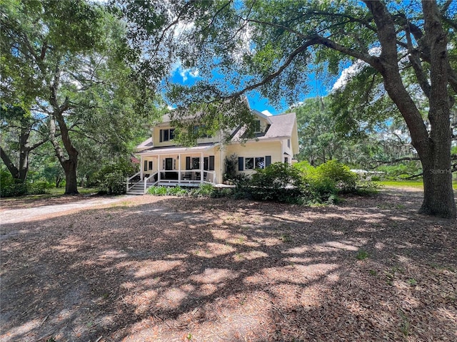 rear view of property with a porch