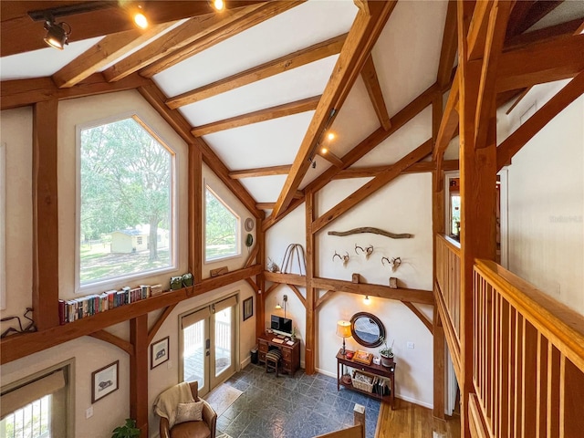 living area featuring plenty of natural light and french doors