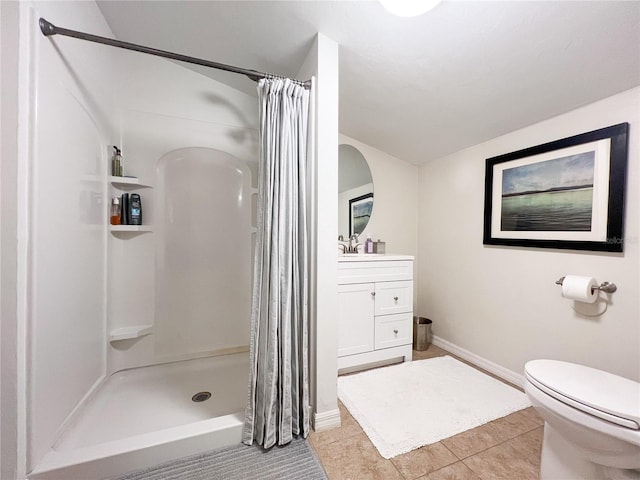 full bathroom featuring a stall shower, toilet, tile patterned flooring, vanity, and baseboards