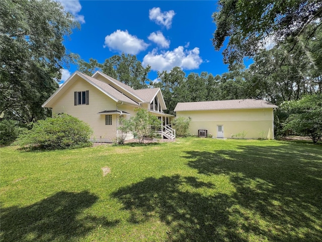 back of property with a yard