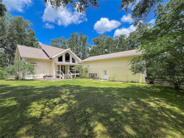 rear view of house with a lawn
