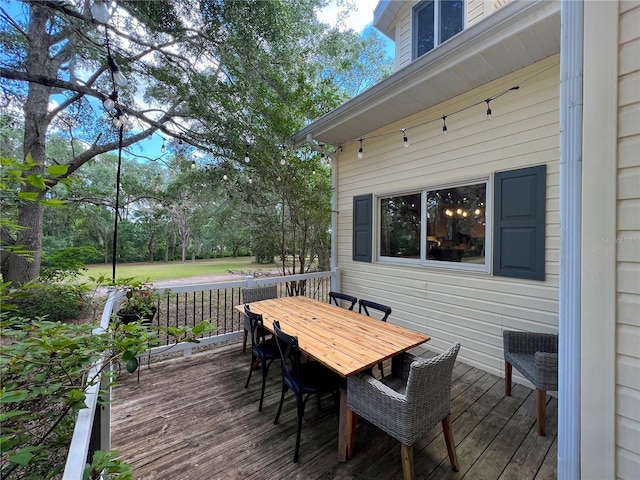 wooden terrace featuring outdoor dining area