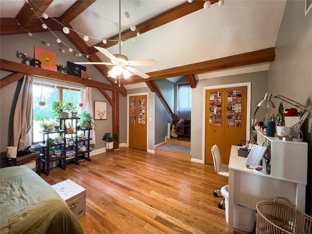 bedroom featuring multiple windows, light wood finished floors, and baseboards
