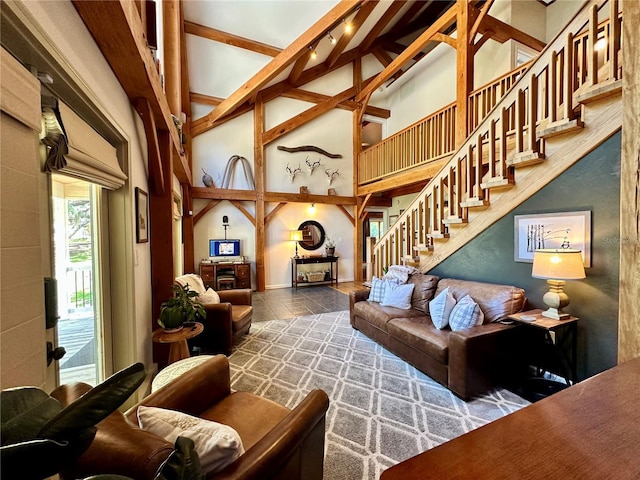 living room featuring high vaulted ceiling, stairway, and beamed ceiling