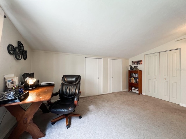 carpeted office space featuring lofted ceiling