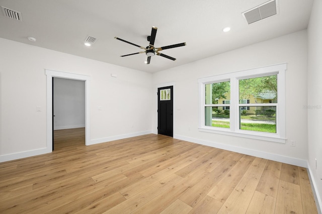 unfurnished room with healthy amount of natural light, light wood-style floors, baseboards, and recessed lighting