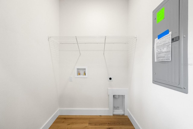 laundry area featuring hookup for a washing machine, hookup for an electric dryer, wood finished floors, and baseboards