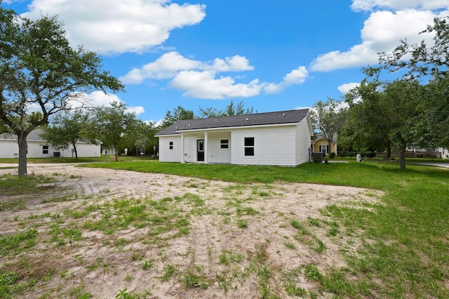 back of property with a lawn