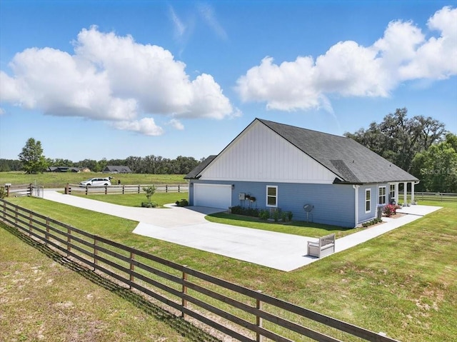 view of side of home featuring concrete driveway
