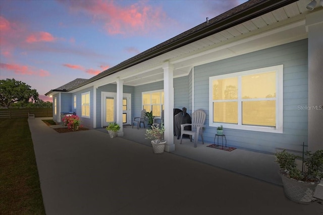 view of patio with covered porch and fence