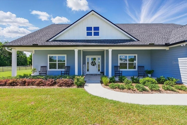view of front of property with board and batten siding, a shingled roof, and a porch