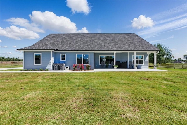 back of house featuring a patio area and roof with shingles