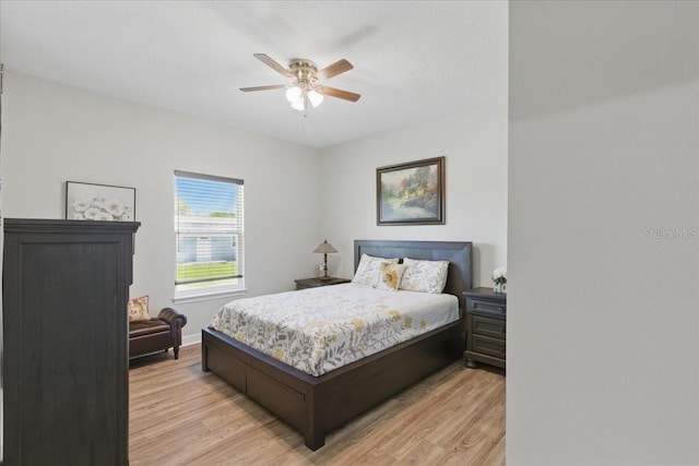 bedroom with light wood-type flooring, ceiling fan, and baseboards
