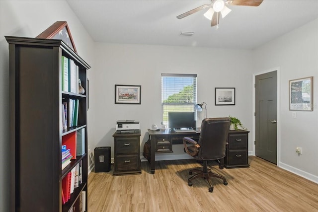 office space with light wood-style flooring, ceiling fan, and baseboards