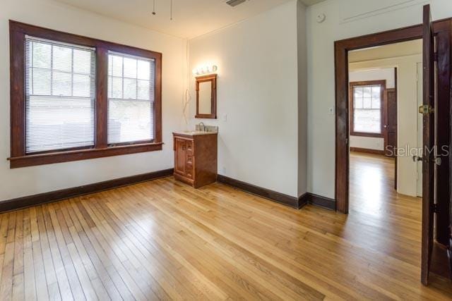 113 NW 11th St Unit 1/2, Gainesville, FL 32601 - empty room featuring light wood-style floors and baseboards