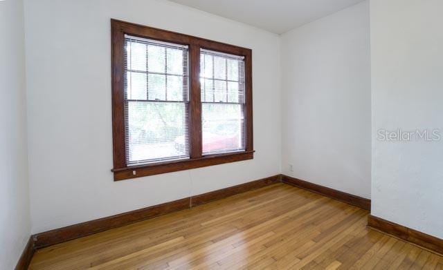 113 NW 11th St Unit 1/2, Gainesville, FL 32601 - spare room with baseboards and light wood finished floors