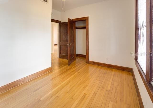 113 NW 11th St Unit 1/2, Gainesville, FL 32601 - unfurnished bedroom featuring baseboards and light wood finished floors