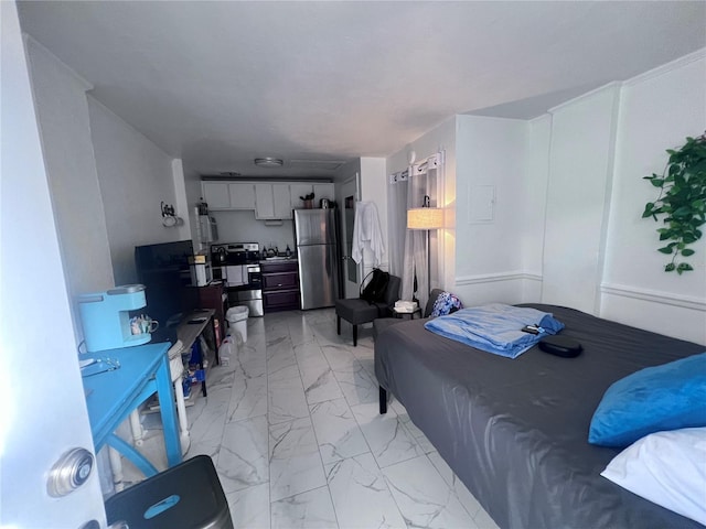 113 NW 11th St Unit 1/2, Gainesville, FL 32601 - bedroom with freestanding refrigerator and light marble finish floors